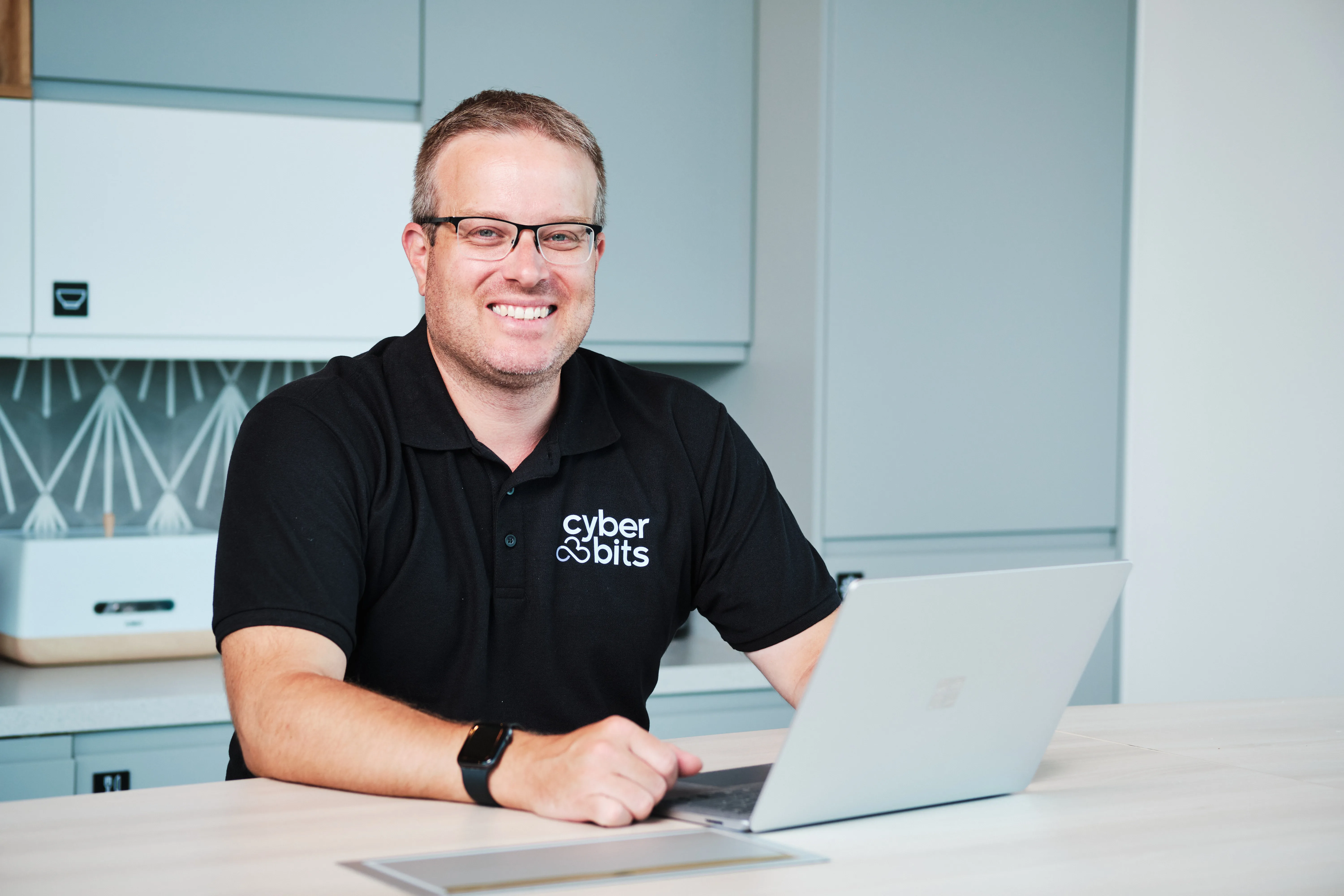 Rob Shaw, founder of CyberBITS, working at his laptop in the Cannock office